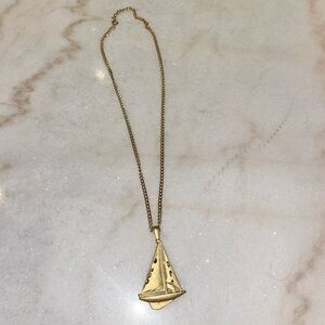 Gold chain with sailboat charm
